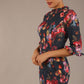 Model wearing the Portofino frill neck floral jacquard dress against a plain background (Hidcote Floral)