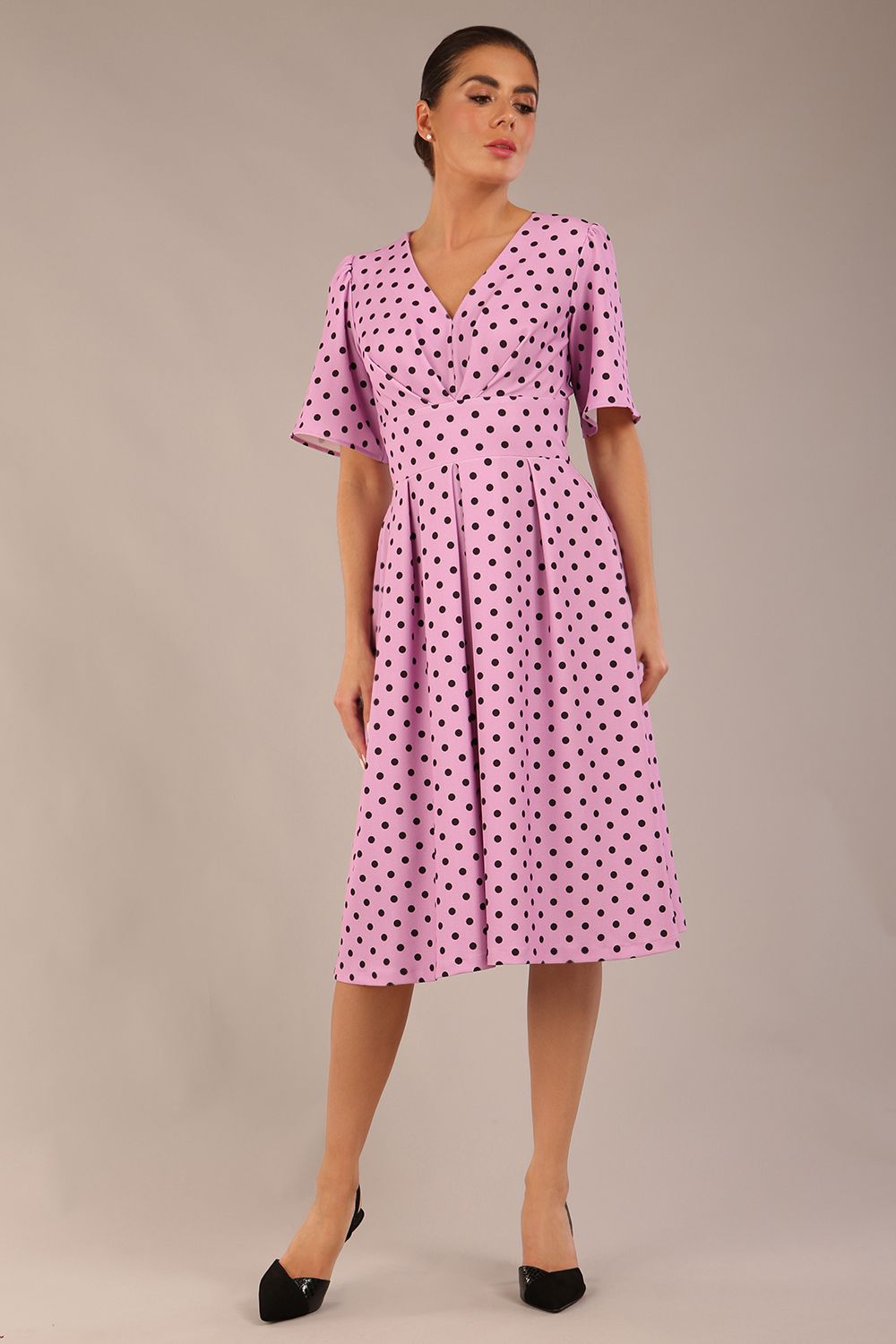 brunette model is wearing a diva catwalk Myriad Polka Dot V Neck & Bat Sleeves Midi Dress in orchid polka dot front image