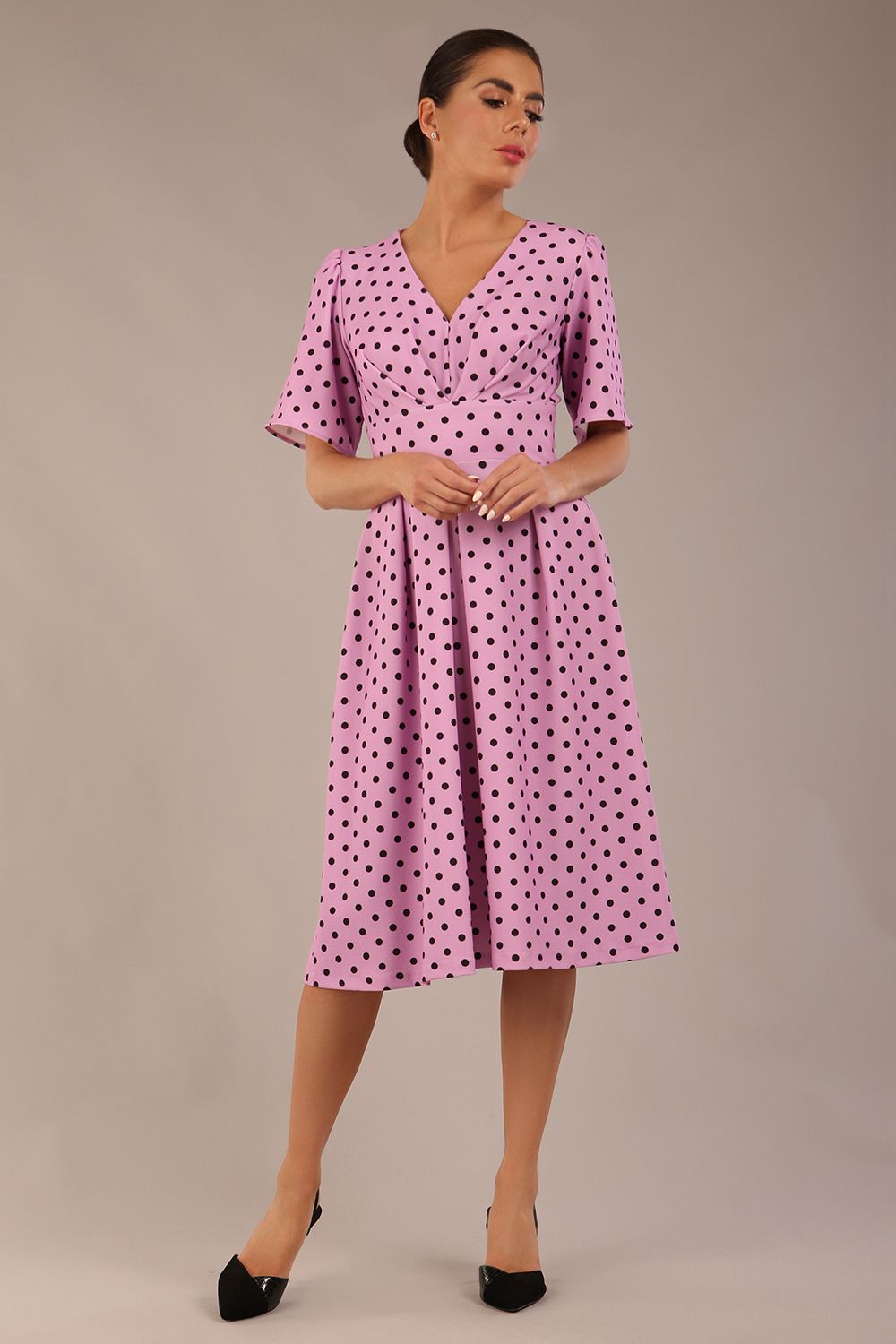 brunette model is wearing a diva catwalk Myriad Polka Dot V Neck & Bat Sleeves Midi Dress in orchid polka dot front image