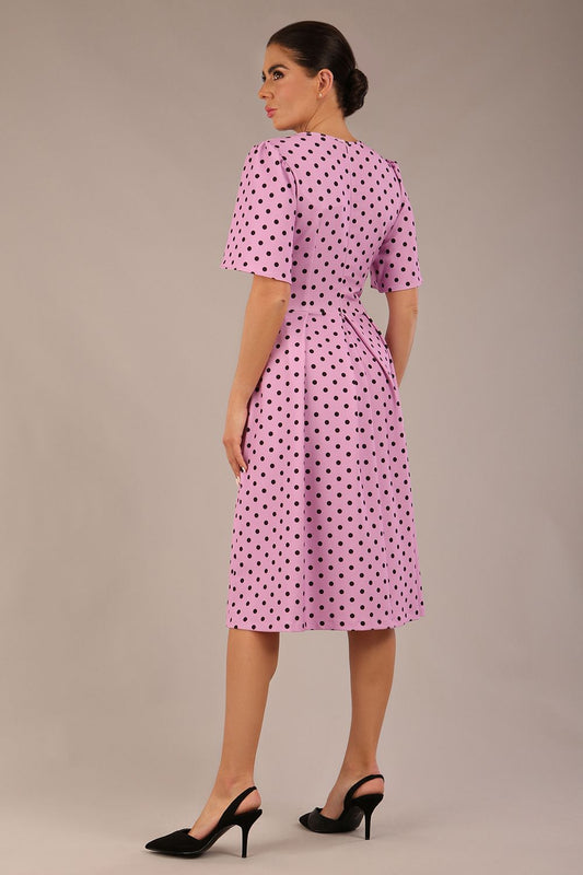 brunette model is wearing a diva catwalk Myriad Polka Dot V Neck & Bat Sleeves Midi Dress in orchid polka dot back image