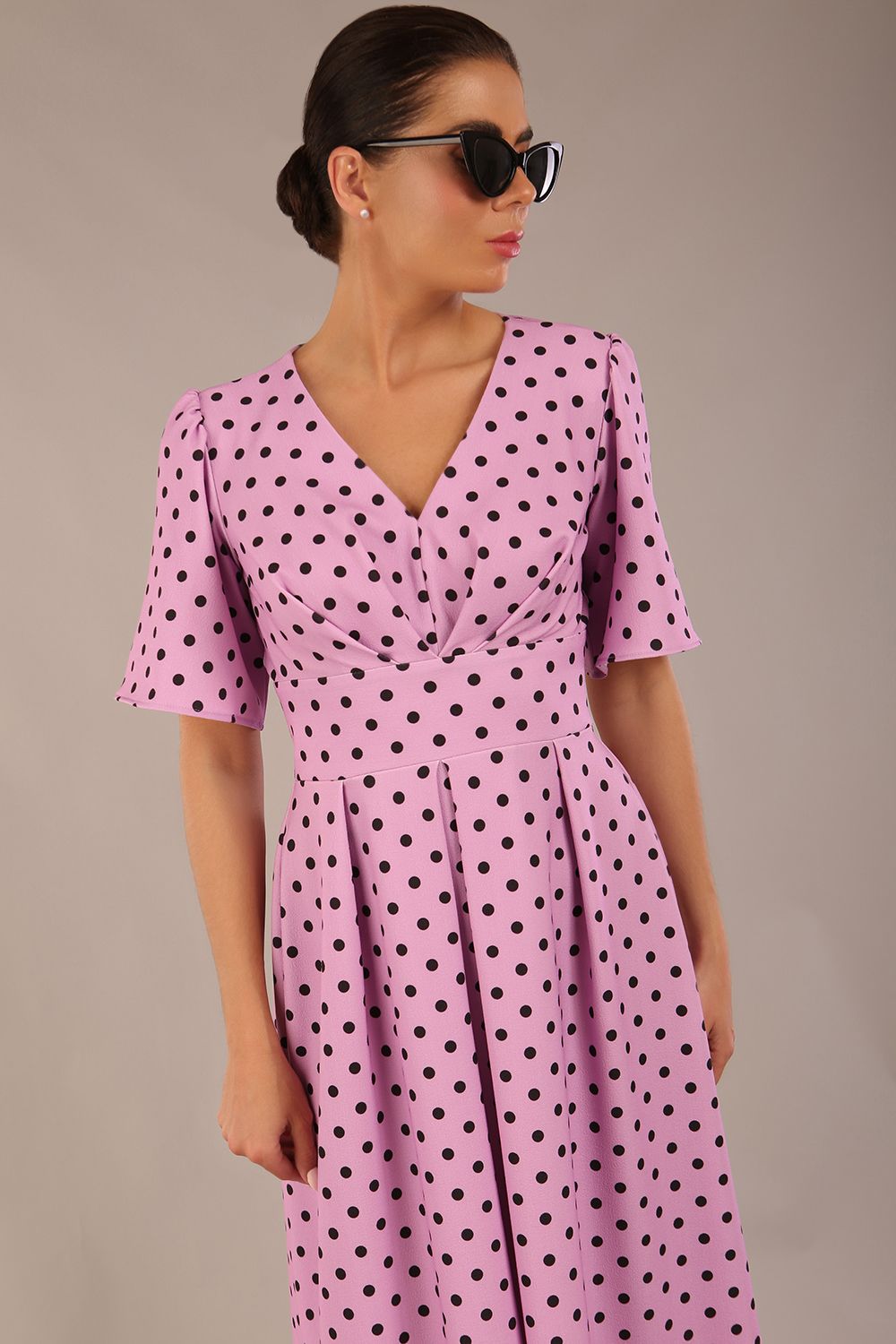 brunette model is wearing a diva catwalk Myriad Polka Dot V Neck & Bat Sleeves Midi Dress in orchid polka dot front image