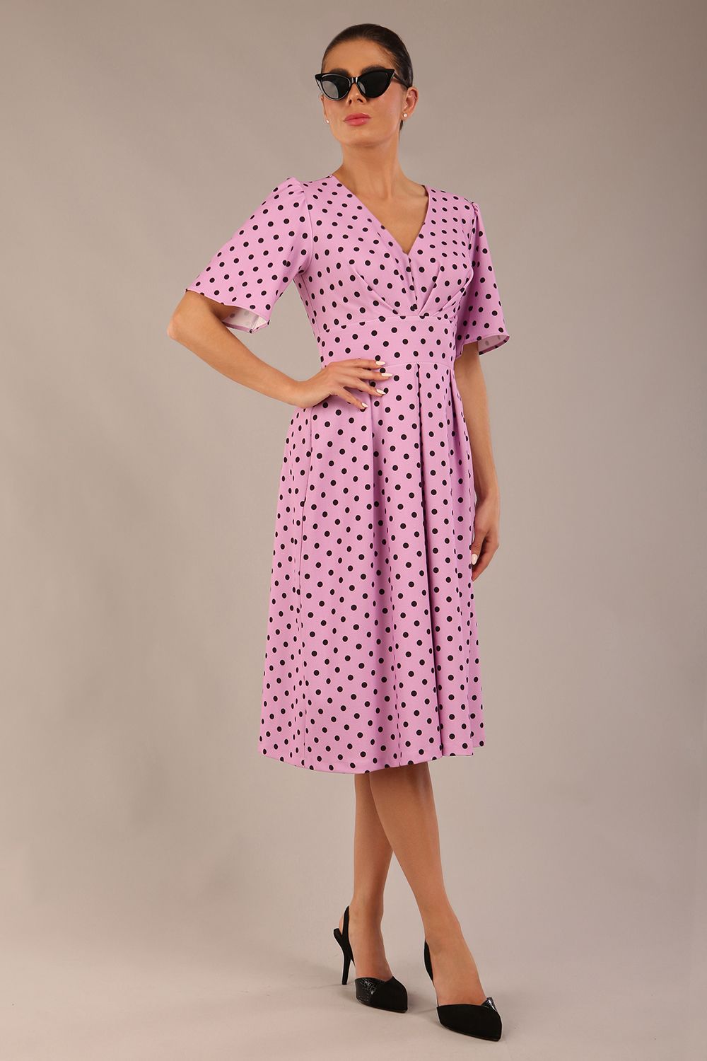 brunette model is wearing a diva catwalk Myriad Polka Dot V Neck & Bat Sleeves Midi Dress in orchid polka dot front image