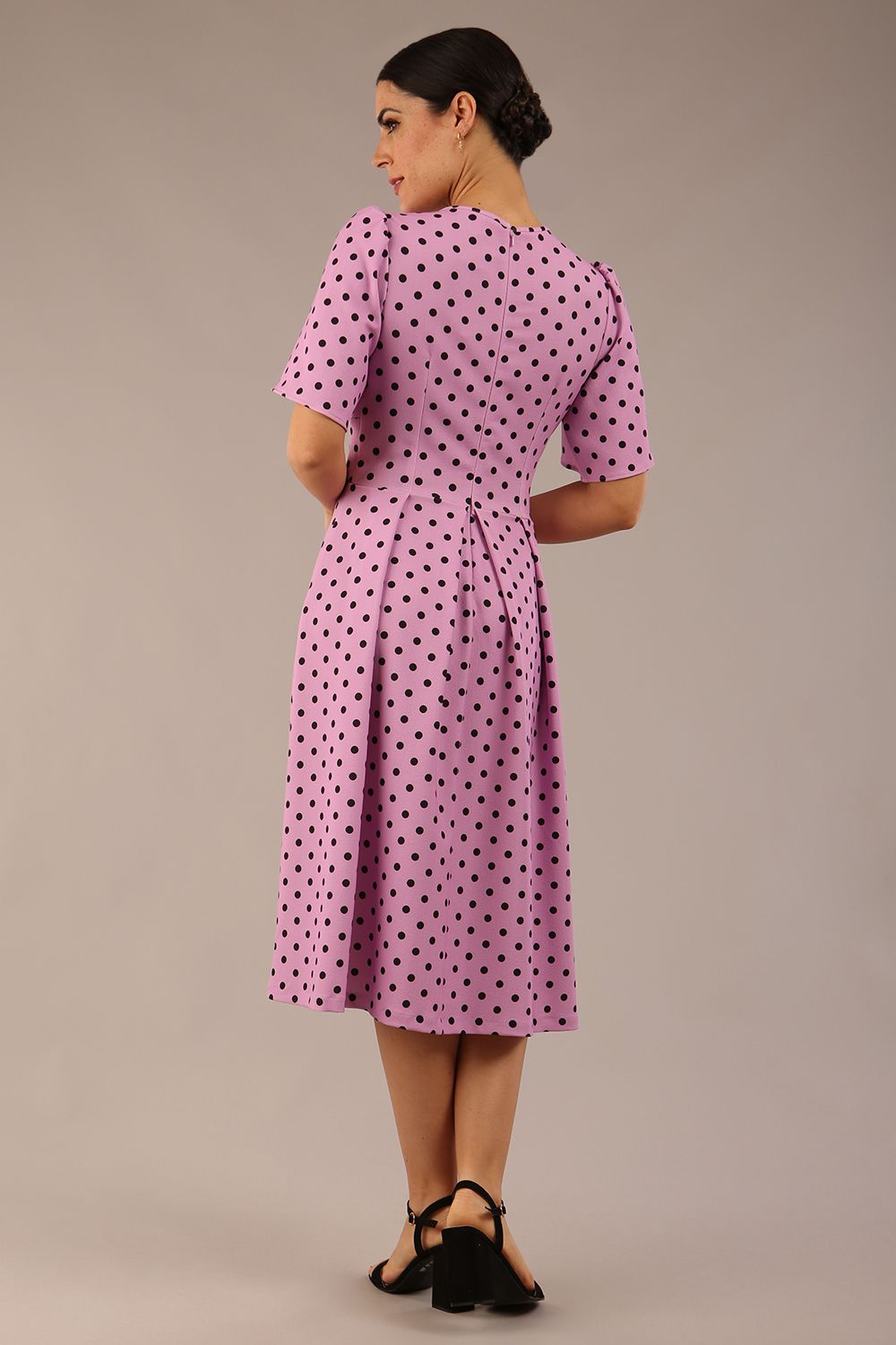 brunette model is wearing a diva catwalk Myriad Polka Dot V Neck & Bat Sleeves Midi Dress in orchid polka dot back image