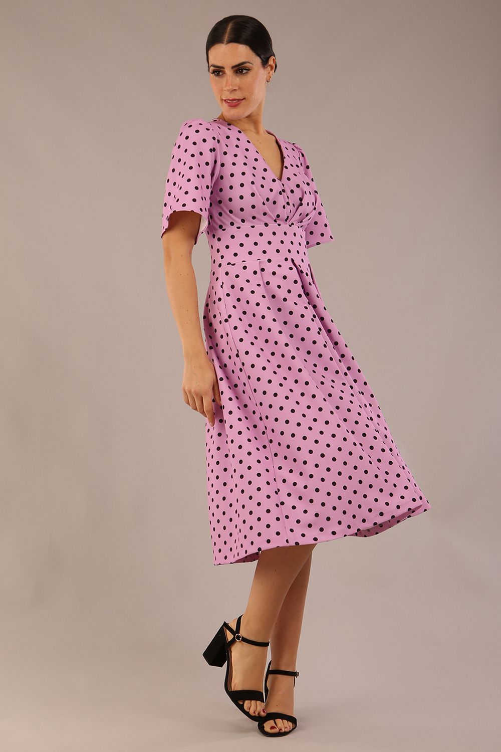 brunette model is wearing a diva catwalk Myriad Polka Dot V Neck & Bat Sleeves Midi Dress in orchid polka dot front image