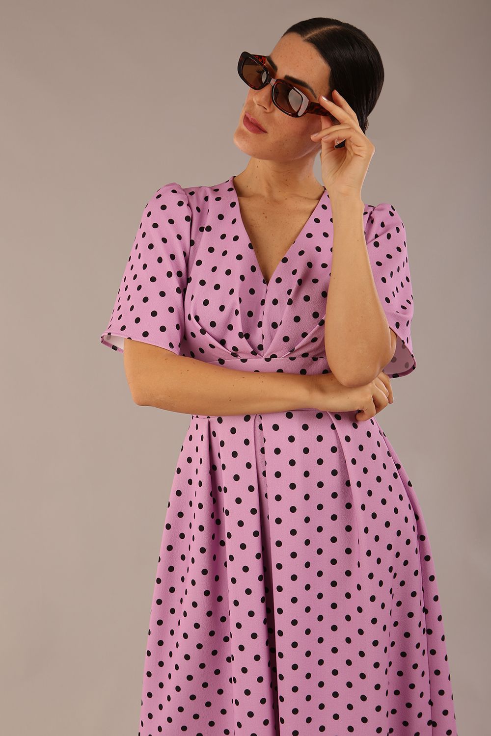 brunette model is wearing a diva catwalk Myriad Polka Dot V Neck & Bat Sleeves Midi Dress in orchid polka dot front image