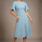 brunette model is wearing a diva catwalk Anastasia Polka Dot Bell Sleeves & A-Line Skirt Midi Dress a-line dress in sky blue polka dot front image (Sky Blue Polka Dot)