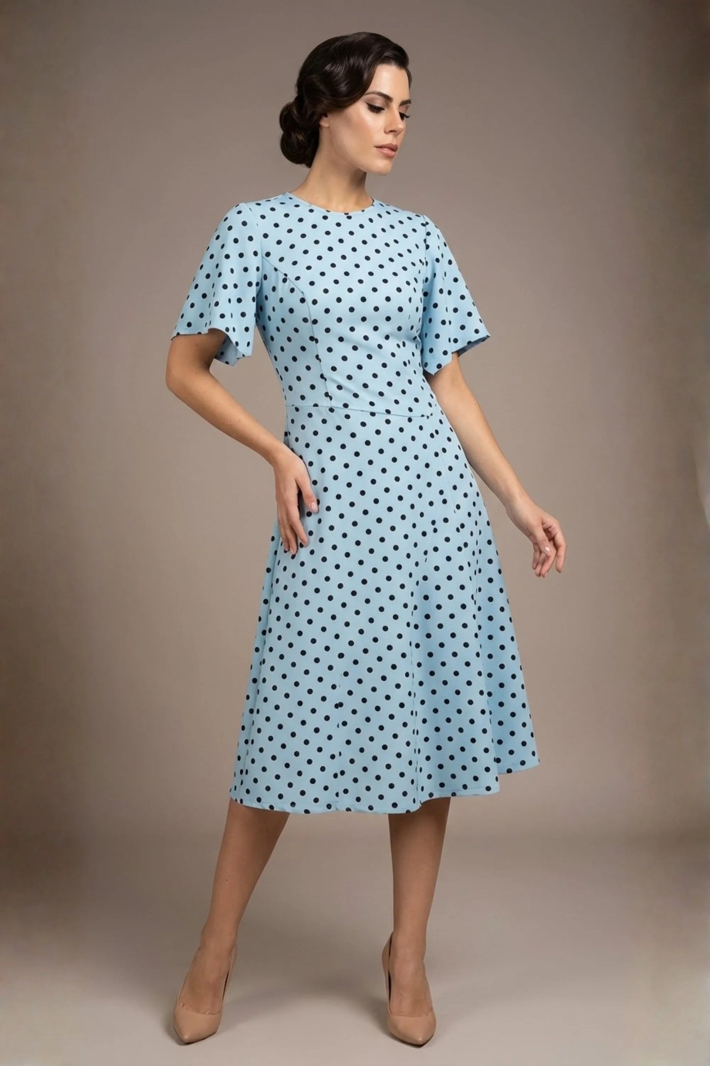 brunette model is wearing a diva catwalk Anastasia Polka Dot Bell Sleeves & A-Line Skirt Midi Dress a-line dress in sky blue polka dot front image (Sky Blue Polka Dot)