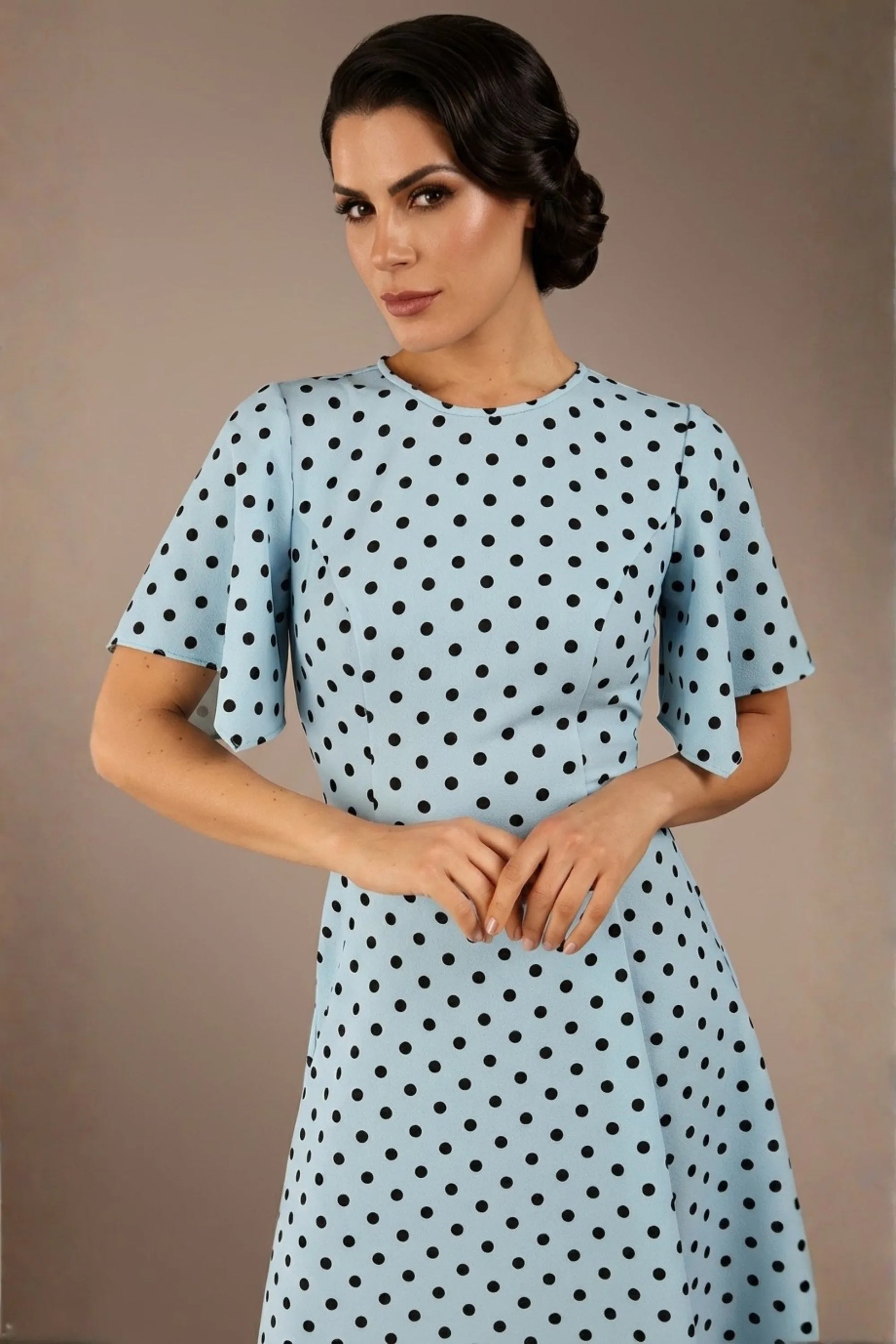 brunette model is wearing a diva catwalk Anastasia Polka Dot Bell Sleeves & A-Line Skirt Midi Dress a-line dress in sky blue polka dot front image (Sky Blue Polka Dot)
