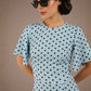 brunette model is wearing a diva catwalk Anastasia Polka Dot Bell Sleeves & A-Line Skirt Midi Dress a-line dress in sky blue polka dot front image (Sky Blue Polka Dot)