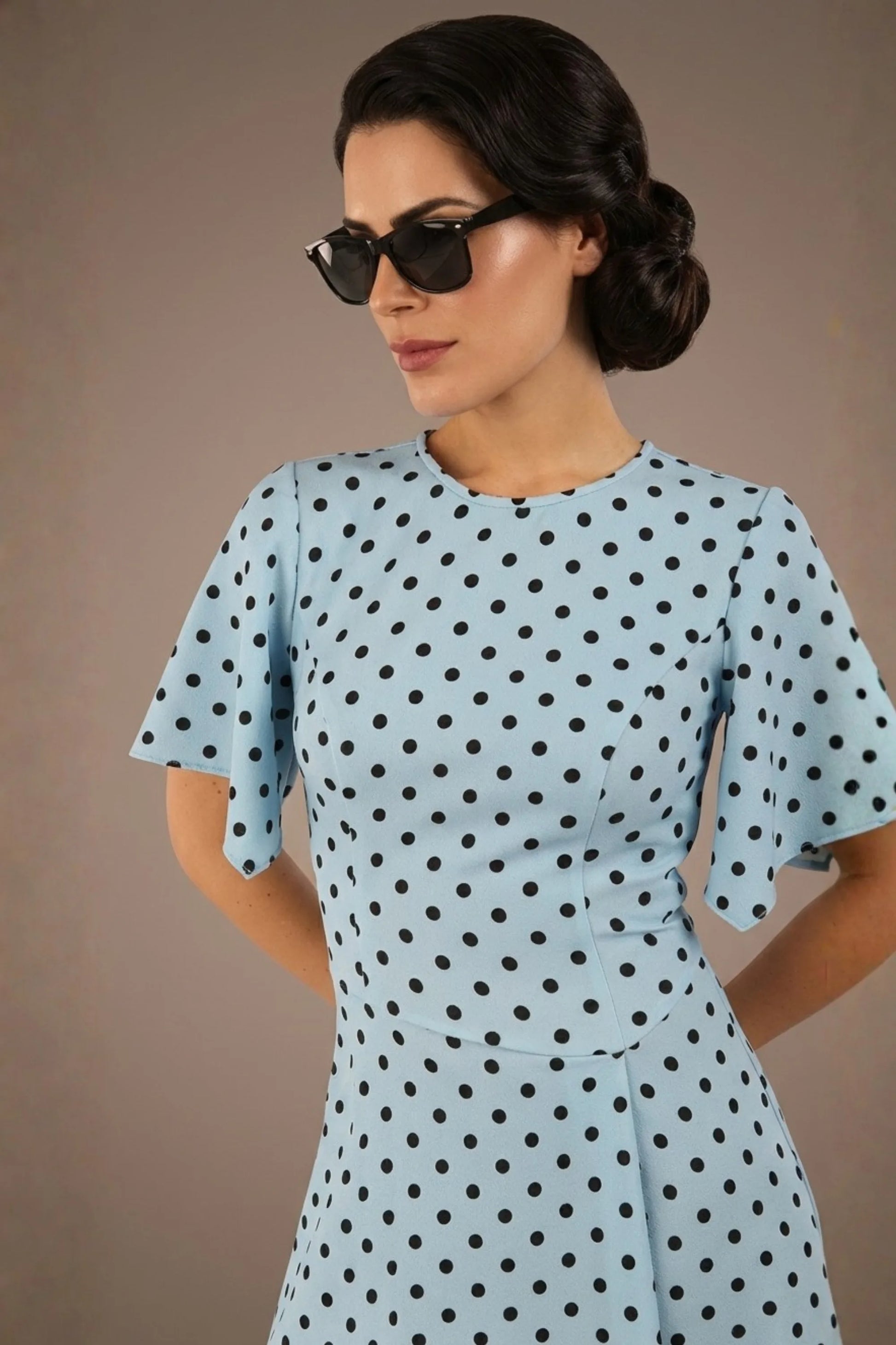 brunette model is wearing a diva catwalk Anastasia Polka Dot Bell Sleeves & A-Line Skirt Midi Dress a-line dress in sky blue polka dot front image (Sky Blue Polka Dot)