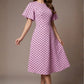 brunette model is wearing a diva catwalk Anastasia Polka Dot Bell Sleeves & A-Line Skirt Midi Dress a-line dress in orchid polka dot front image (Orchid Polka Dot)