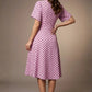 brunette model is wearing a diva catwalk Anastasia Polka Dot Bell Sleeves & A-Line Skirt Midi Dress a-line dress in orchid polka dot front image (Orchid Polka Dot)