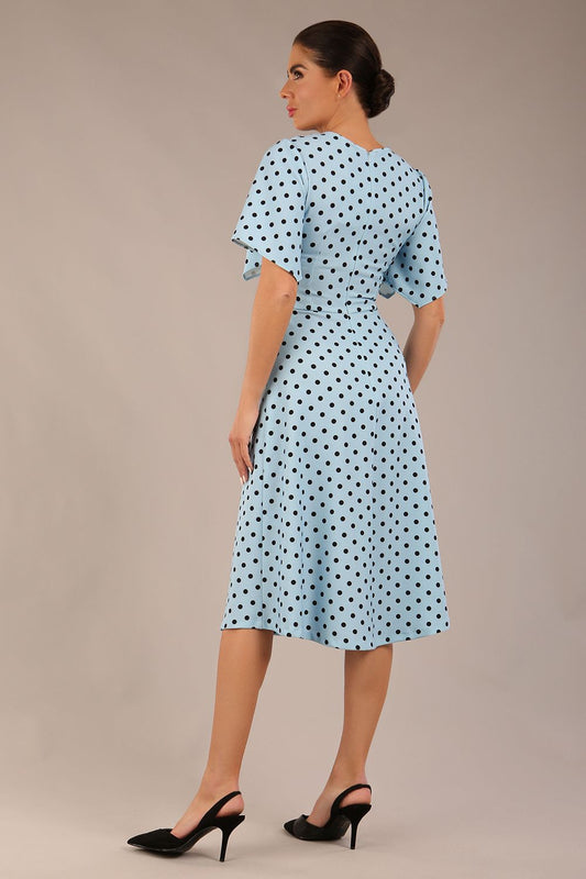 brunette model is wearing a diva catwalk Anastasia Polka Dot Bell Sleeves & A-Line Skirt Midi Dress a-line dress in sky blue polka dot back image