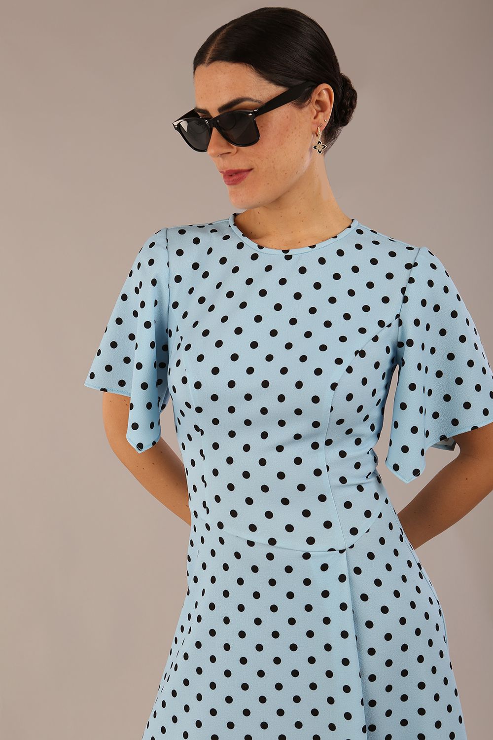 brunette model is wearing a diva catwalk Anastasia Polka Dot Bell Sleeves & A-Line Skirt Midi Dress a-line dress in sky blue polka dot front image