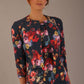 Model wearing the Valetta cropped floral jacquard jacket over a matching dress with a plain background (Hidcote Floral)