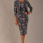 Model wearing the Valetta cropped floral jacquard jacket over a matching dress with a plain background (Navy Floral)