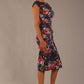 Model wearing the Nora asymmetric floral jacquard dress, showcasing the unique draped neckline (Hidcote Floral)