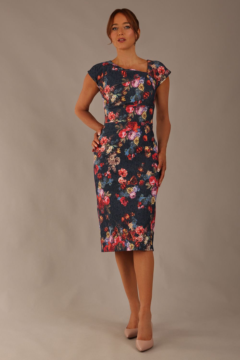 Model wearing the Nora asymmetric floral jacquard dress, showcasing the unique draped neckline (Hidcote Floral)