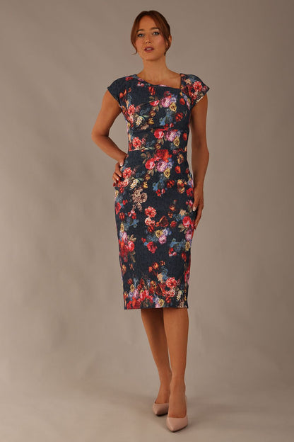 Model wearing the Nora asymmetric floral jacquard dress, showcasing the unique draped neckline (Hidcote Floral)