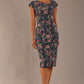 Model wearing the Nora asymmetric floral jacquard dress, showcasing the unique draped neckline (Navy Floral)