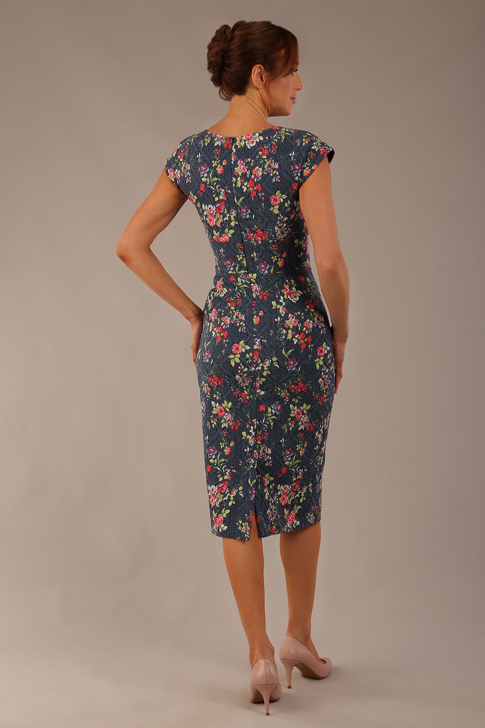 back view Model wearing the Nora asymmetric floral jacquard dress, showcasing the unique draped neckline (Navy Floral)