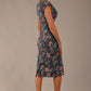side view Model wearing the Nora asymmetric floral jacquard dress, showcasing the unique draped neckline (Navy Floral)