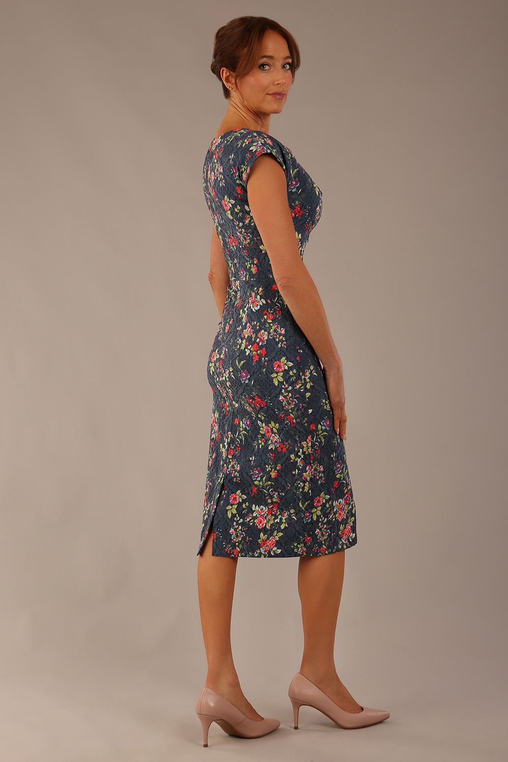 side view Model wearing the Nora asymmetric floral jacquard dress, showcasing the unique draped neckline (Navy Floral)