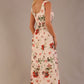 blonde model is wearing a 7000 diva catwalk Glyndebourne Sleeveless Square Neck Maxi Dress in Rose Blush print with pockets back