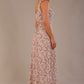 blonde model is wearing a 7000 diva catwalk Glyndebourne Sleeveless Square Neck Maxi Dress in tudor vine print with pockets back