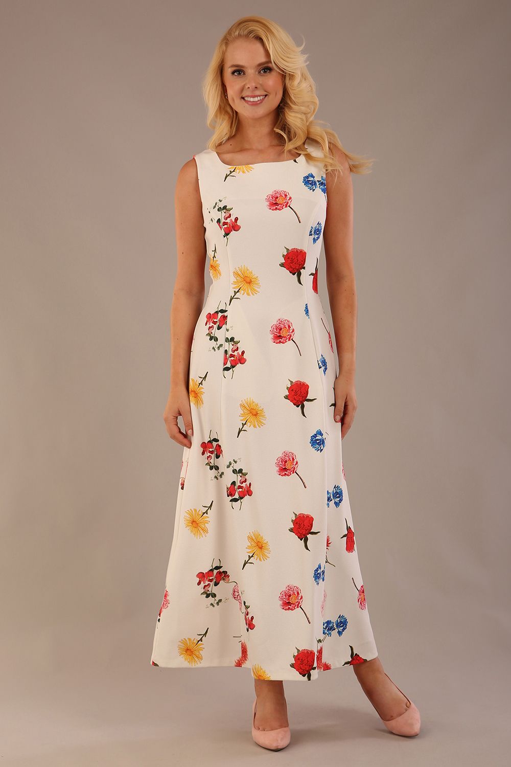 blonde model is wearing a 7000 diva catwalk Glyndebourne Sleeveless Square Neck Maxi Dress in buttercup print with pockets front