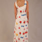 blonde model is wearing a 7000 diva catwalk Glyndebourne Sleeveless Square Neck Maxi Dress in buttercup print with pockets back