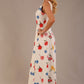 blonde model is wearing a 7000 diva catwalk Glyndebourne Sleeveless Square Neck Maxi Dress in buttercup print with pockets side