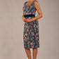 brunette model is wearing a diva catwalk June Floral Sleeveless Navy Waistband Pencil Dress in floral blue print front image
