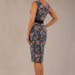 brunette model is wearing a diva catwalk June Floral Sleeveless Navy Waistband Pencil Dress in floral blue print back image