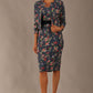 brunette model is wearing a diva catwalk June Floral Sleeveless Navy Waistband Pencil Dress in floral blue print front image with valetta jacket