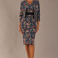 brunette model is wearing a diva catwalk June Floral Sleeveless Navy Waistband Pencil Dress in floral blue print front image with valetta jacket