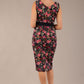 brunette model is wearing a diva catwalk June Floral Sleeveless Navy Waistband Pencil Dress in Navy Spring Rose back image