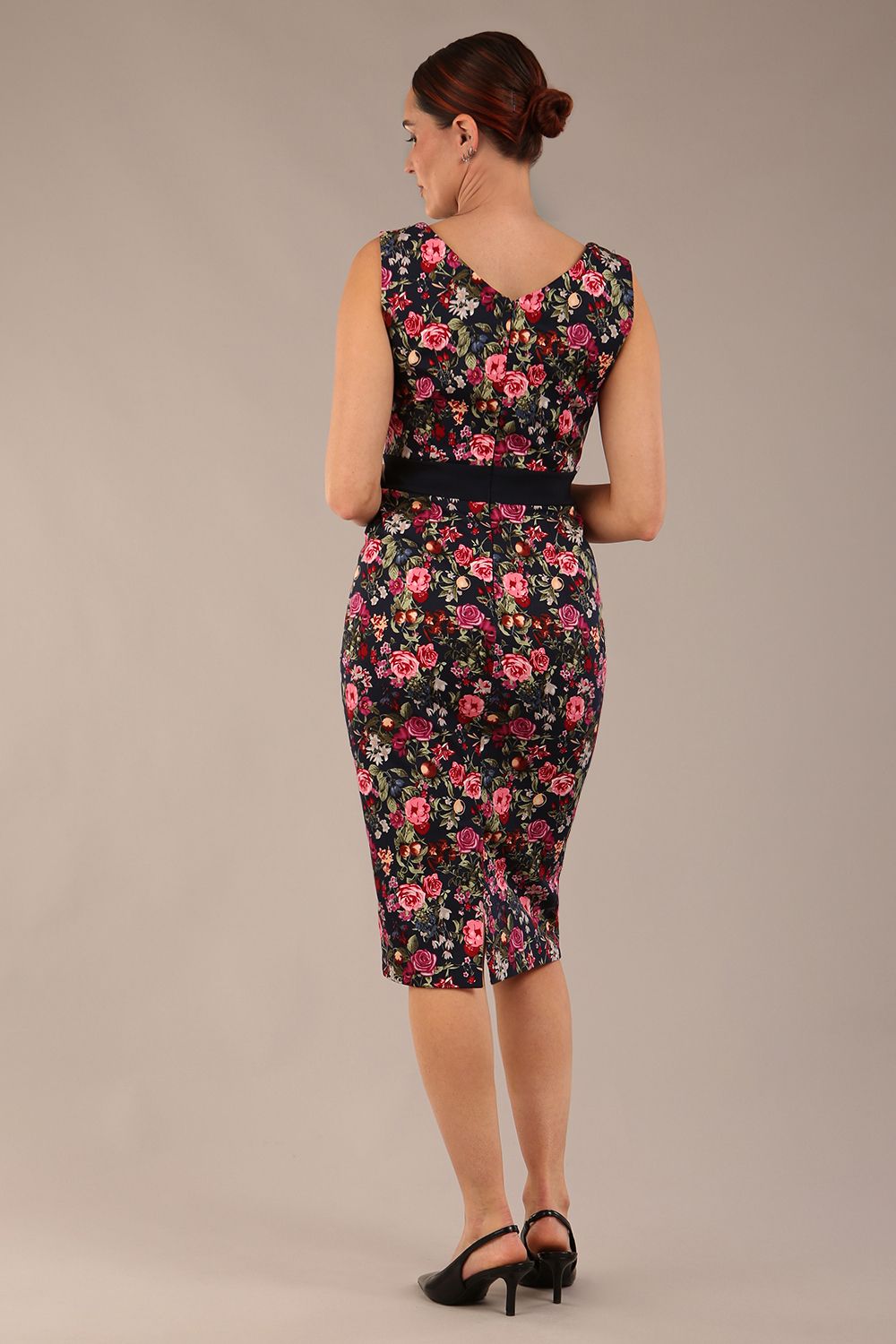 brunette model is wearing a diva catwalk June Floral Sleeveless Navy Waistband Pencil Dress in Navy Spring Rose back image