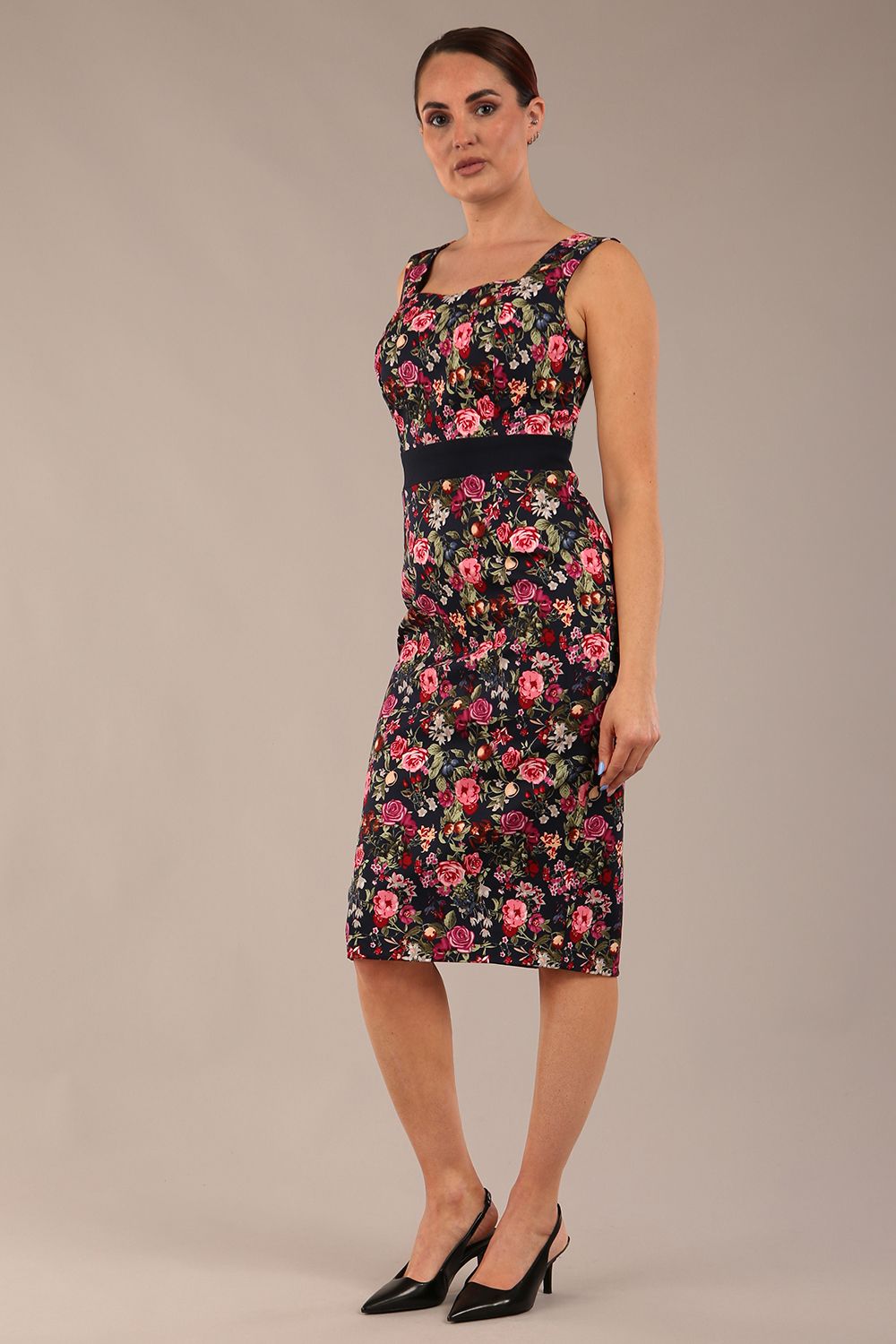 brunette model is wearing a diva catwalk June Floral Sleeveless Navy Waistband Pencil Dress in Navy Spring Rose front image