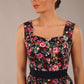 brunette model is wearing a diva catwalk June Floral Sleeveless Navy Waistband Pencil Dress in Navy Spring Rose front image close up