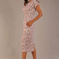 brunette model is wearing a 7002 diva catwalk Carlisle Boat Neck Short Sleeve Midi Pencil Dress in Tudor Vine print with side pockets front side