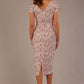 brunette model is wearing a 7002 diva catwalk Carlisle Boat Neck Short Sleeve Midi Pencil Dress in Tudor Vine print with side pockets back
