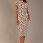brunette model is wearing a 7002 diva catwalk Carlisle Boat Neck Short Sleeve Midi Pencil Dress in Linear Tulip print with side pockets front