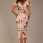 brunette model is wearing a 7002 diva catwalk Carlisle Boat Neck Short Sleeve Midi Pencil Dress in Rose Blush print with side pockets back