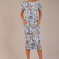 brunette model is wearing a 7002 diva catwalk Carlisle Boat Neck Short Sleeve Midi Pencil Dress in watrer garden print with side pockets front