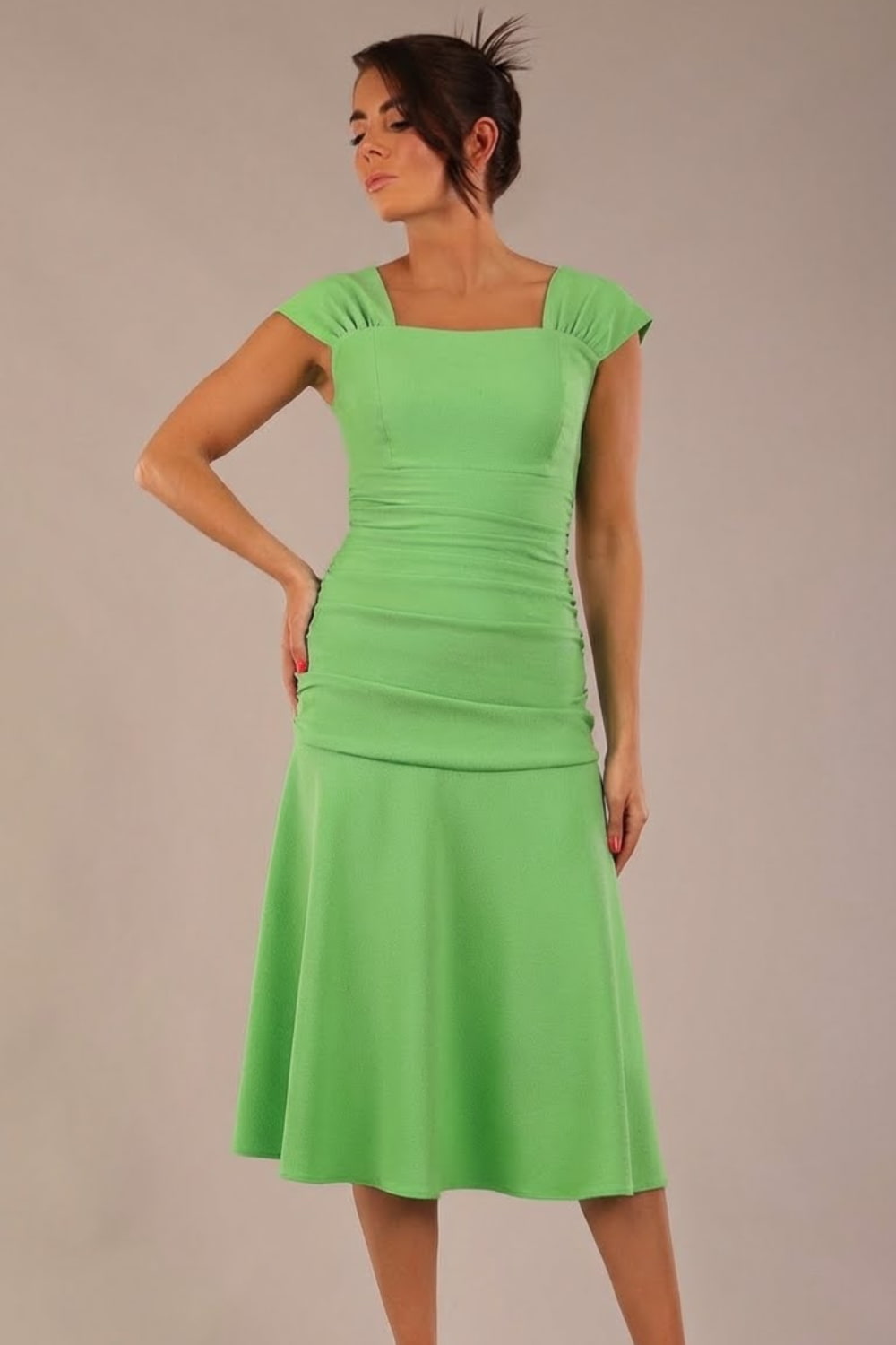 brunette model is wearing a diva catwalk Sonning Cap Sleeve Square Neckline A-Line midi Dress and rushing side details in lime green colour front (Lime Green)