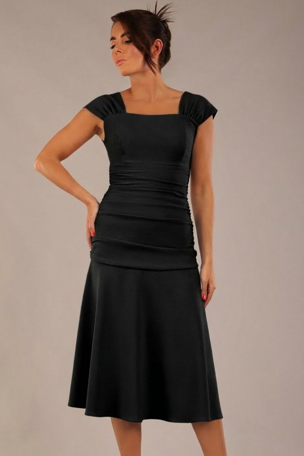 brunette model is wearing a diva catwalk Sonning Cap Sleeve Square Neckline A-Line midi Dress and rushing side details in Black colour front (Black)