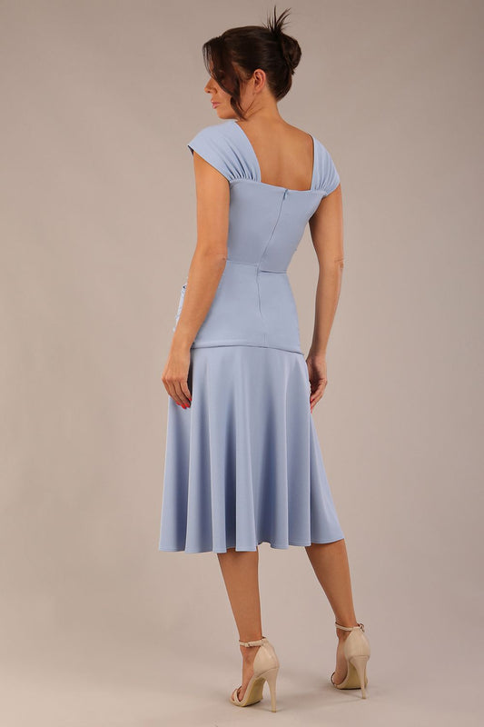 brunette model is wearing a diva catwalk Sonning Cap Sleeve Square Neckline A-Line midi Dress and rushing side details in powder blue colour back
