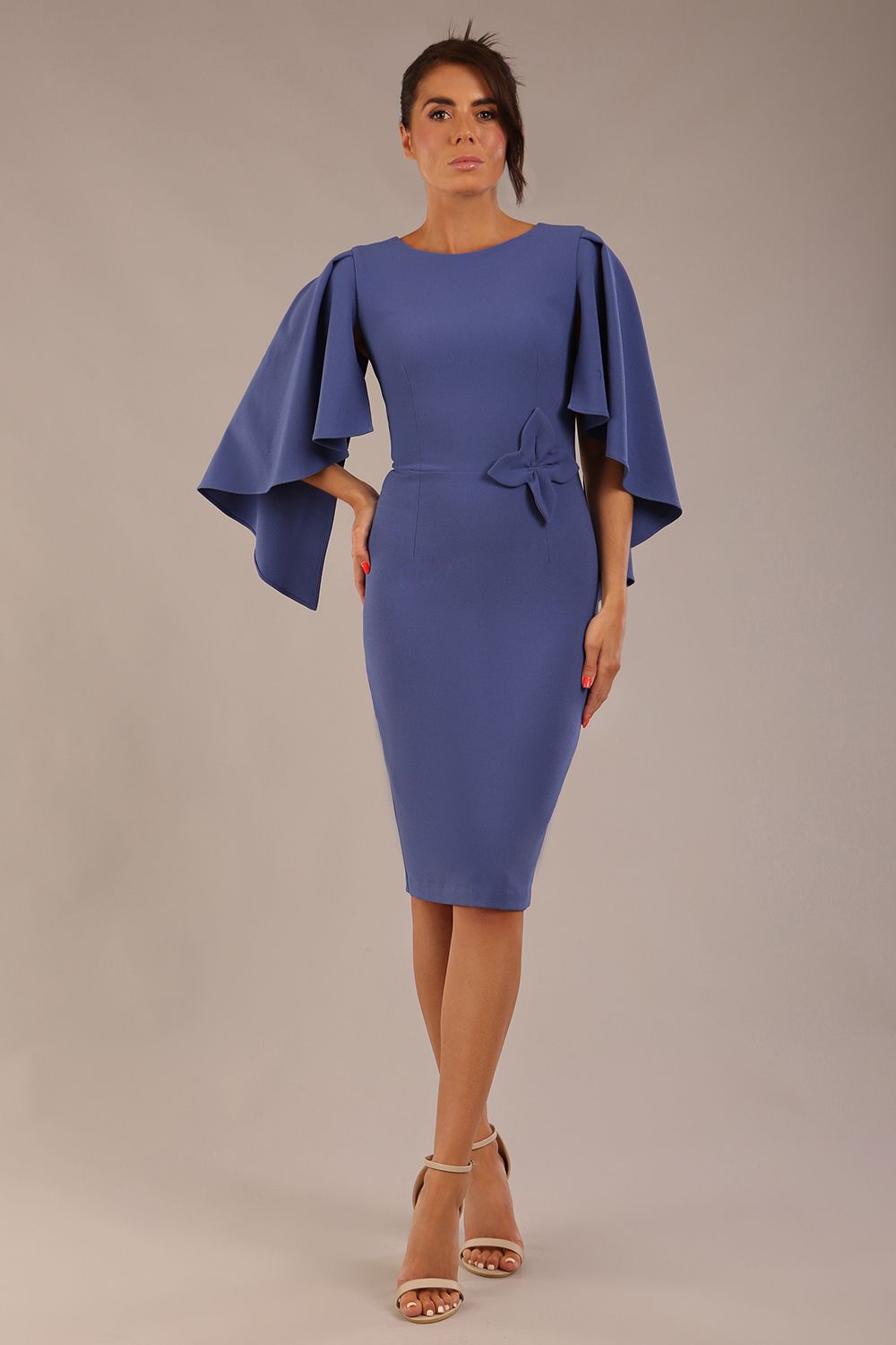 brunette model is wearing a diva catwalk Luella Dolman Sleeve Knee-Length Pencil Dress round neckline with a Four-petal floral detail at the waist and Soft V-shaped back neckline in dutch blue colour front 