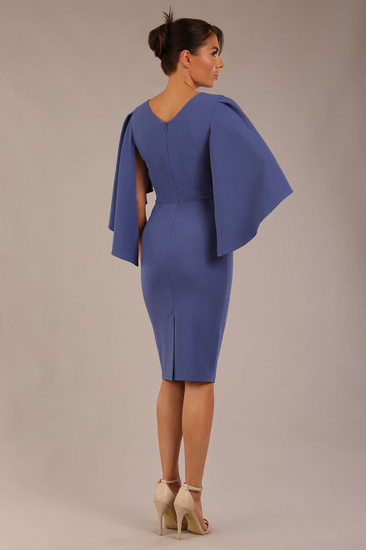 brunette model is wearing a diva catwalk Luella Dolman Sleeve Knee-Length Pencil Dress round neckline with a Four-petal floral detail at the waist and Soft V-shaped back neckline in dutch blue colour back